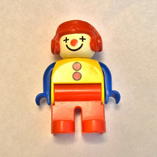 Duplo Figure, Early, Aviator Hat Red, Red Legs, with 2 Buttons, Blue Arms, Clown Face Paint